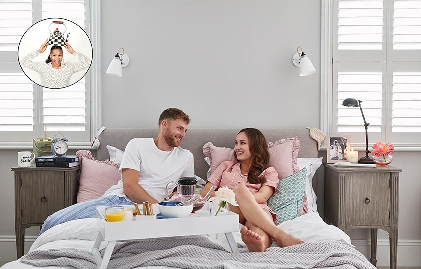 Newly married couple in bed having breakfast in bed